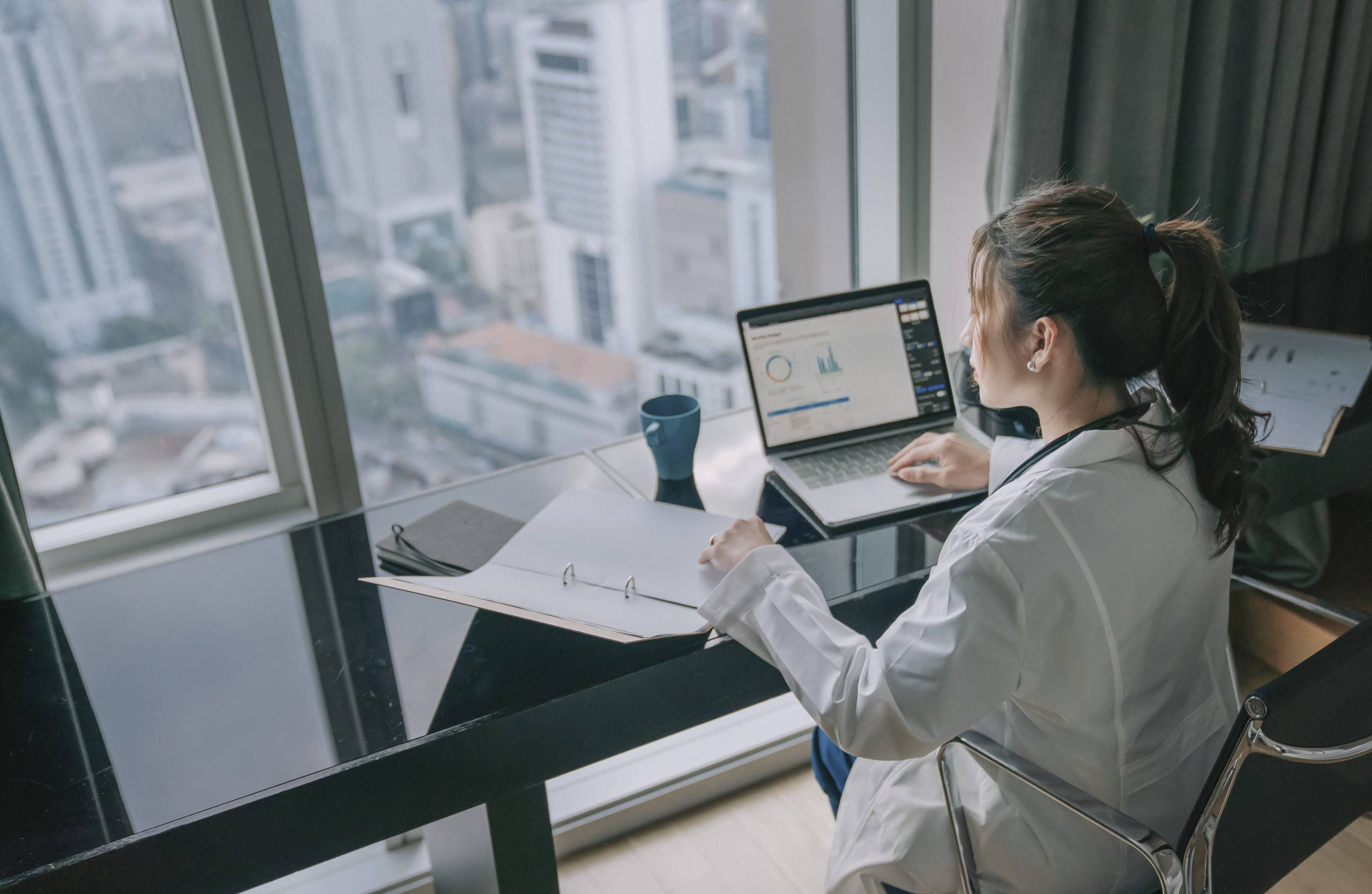 Lean Green Belt asian chinese female doctor working on medical report with laptop and document file asian chinese female doctor working on medical report with laptop and document file